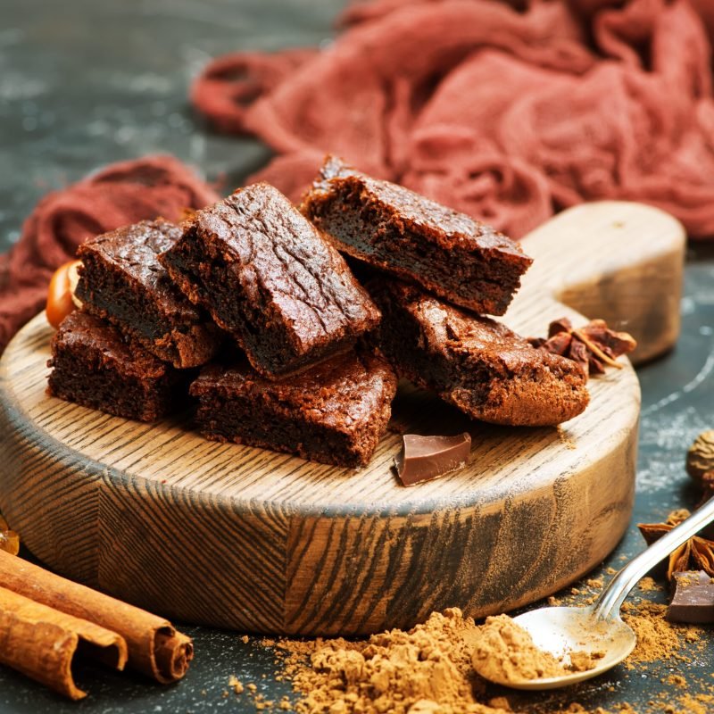 chocolate cake and cocoa powder on a table